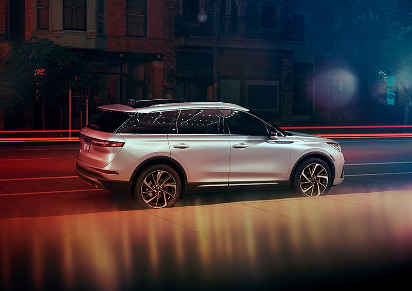 A 2023 Lincoln Corsair® SUV is shown parked in the city at night. | Angela Krause Lincoln of Alpharetta in Alpharetta GA