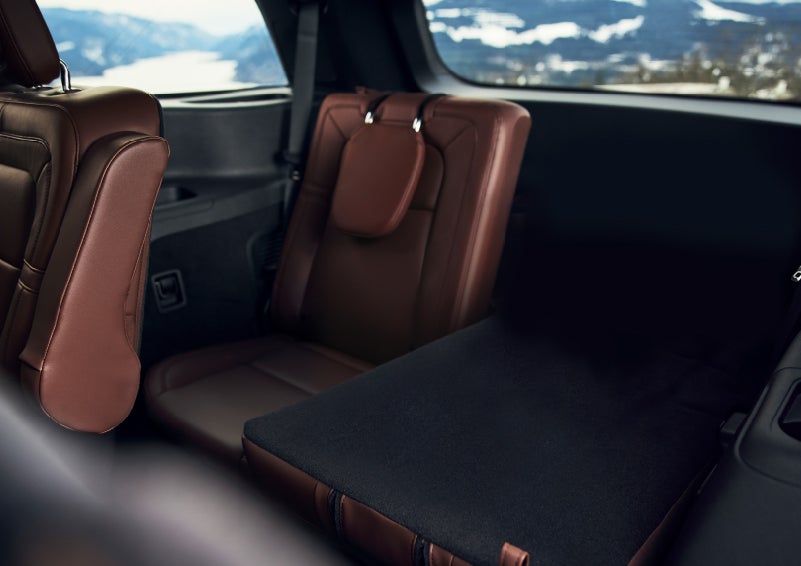 The left rear seat of a 2024 Lincoln Aviator® SUV is shown folded flat for additional cargo space | Angela Krause Lincoln of Alpharetta in Alpharetta GA