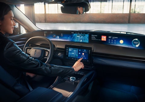 The driver of a 2024 Lincoln Nautilus® SUV interacts with the center touchscreen. | Angela Krause Lincoln of Alpharetta in Alpharetta GA
