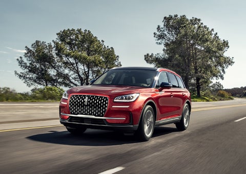 A 2024 Lincoln Corsair® SUV is shown being driven on a country road. | Angela Krause Lincoln of Alpharetta in Alpharetta GA