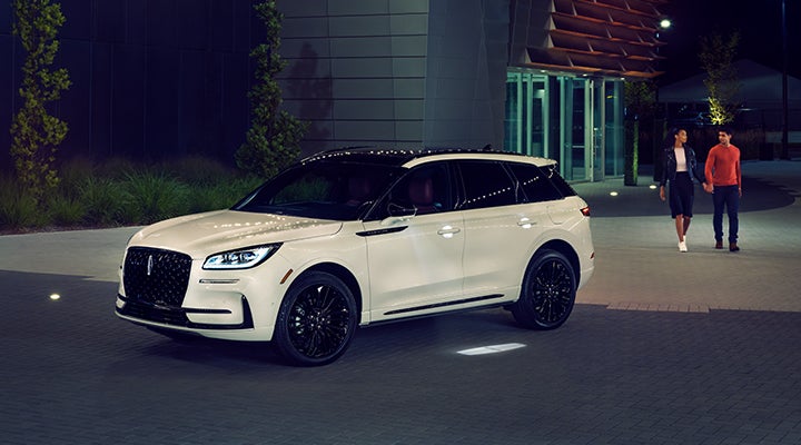 Two people approach a 2024 Lincoln Corsair® SUV featuring the available Jet Appearance Package. | Angela Krause Lincoln of Alpharetta in Alpharetta GA