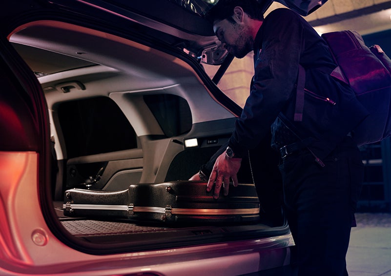 A man is shown loading cargo into the rear of a 2024 Lincoln Corsair® SUV with the second-row seats folded flat. | Angela Krause Lincoln of Alpharetta in Alpharetta GA
