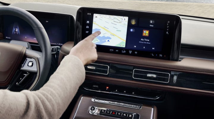 A person is tapping the center display touchscreen of a 2026 Lincoln Aviator® SUV. | Angela Krause Lincoln of Alpharetta in Alpharetta GA