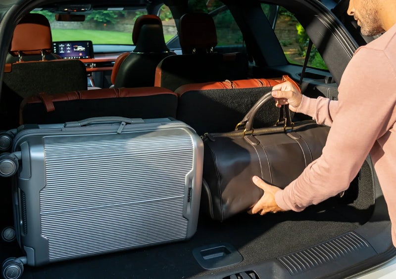 A man loads luggage into the rear of a 2026 Lincoln Aviator® SUV through the opened rear liftgate. | Angela Krause Lincoln of Alpharetta in Alpharetta GA
