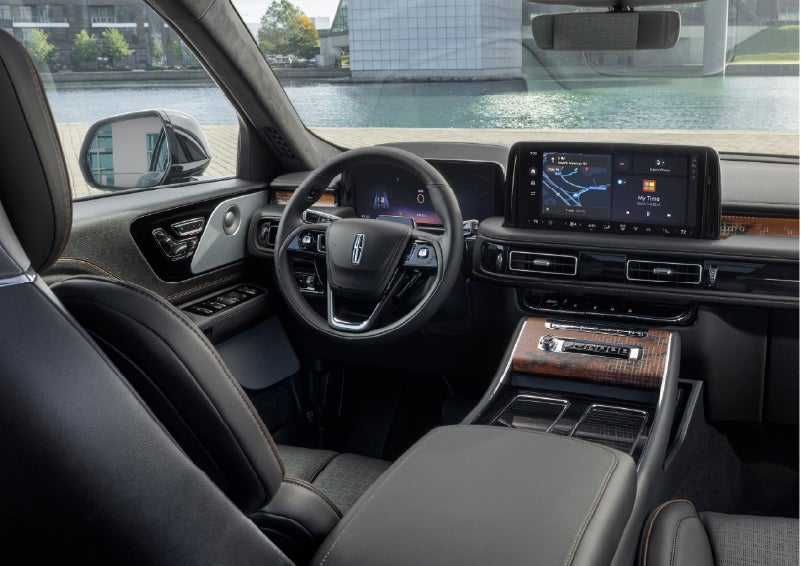 The interior of the 2026 Lincoln Aviator® SUV is shown parked with a view of a harbor through the windshield. | Angela Krause Lincoln of Alpharetta in Alpharetta GA
