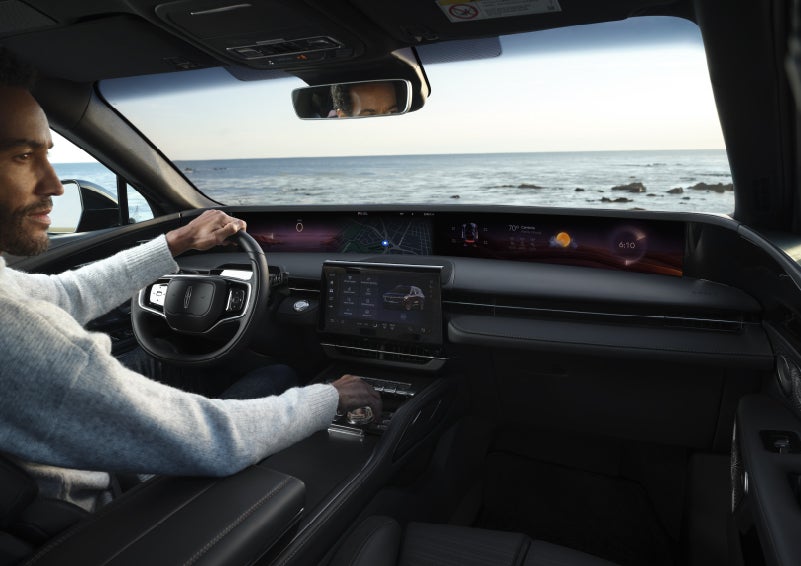 A driver of a parked 2026 Lincoln Nautilus® SUV takes a relaxing moment at a seaside overlook while inside his Nautilus. | Angela Krause Lincoln of Alpharetta in Alpharetta GA