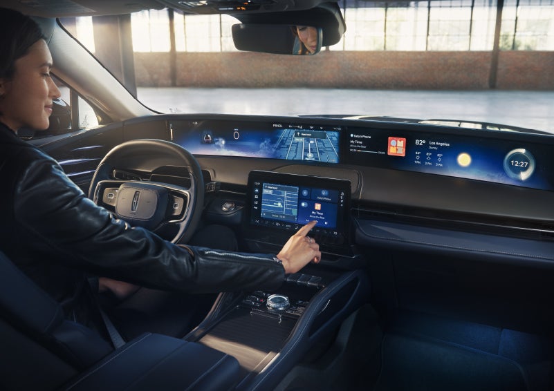 The driver of a 2026 Lincoln Nautilus® SUV interacts with the center touchscreen. | Angela Krause Lincoln of Alpharetta in Alpharetta GA